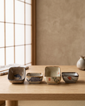 Japanese Ceramic Square Sauce Dishes, Set of 4 — set of four on pale oak in a minimal Japanese dining room showing hand-painted patterns