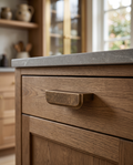 Antique Bronze Drawer Pull, Zinc Alloy — mounted in situ on a luxury kitchen cabinet drawer, warm morning light