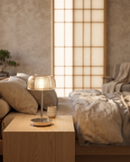 Jellyfish-Inspired Rechargeable LED Table Lamp — hero on an oak bedside table in a serene Japandi bedroom, soft warm glow