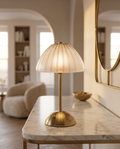 Cordless Crystal-Cut Shade LED Table Lamp, Gold — lamp glowing softly on a polished marble console, modern luxury apartment with brass accents, warm evening ambient light