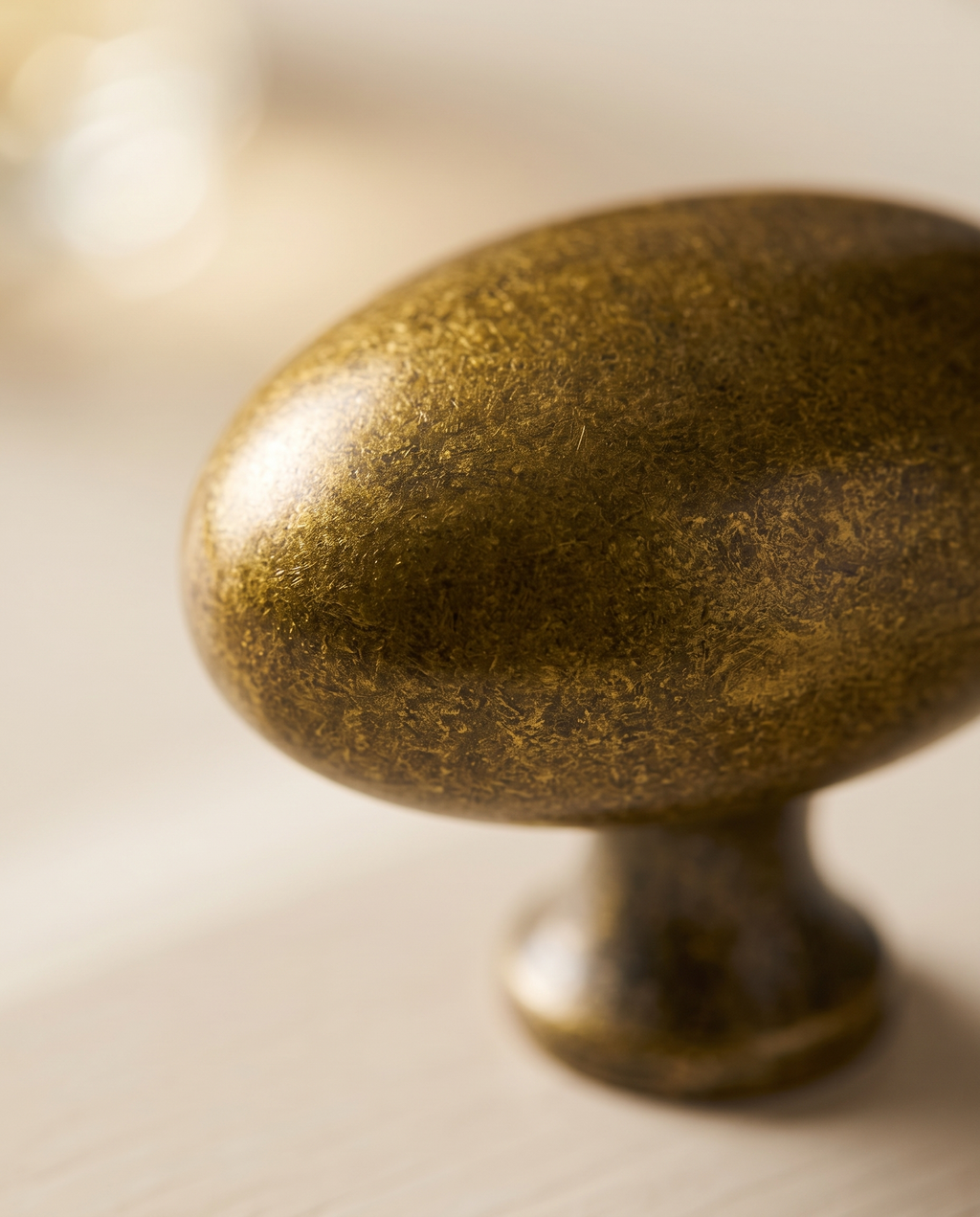 Floral Antique Brass Cabinet Knob — macro detail, antique brass patina and texture under warm side light
