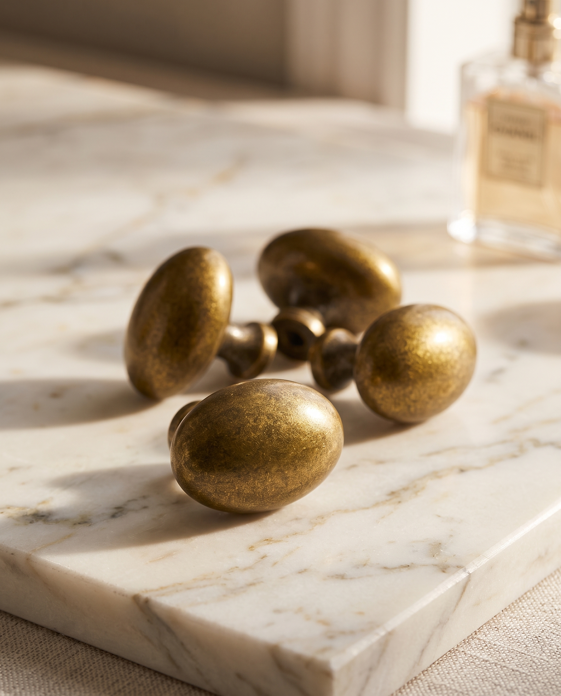 Floral Antique Brass Cabinet Knob — set of knobs grouped on pale marble surface for scale, vintage luxury styling