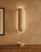 Travertine Stone LED Wall Sconce, G9 — hero, mounted on aged-plaster Mediterranean villa wall, warm soft glow