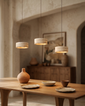 Travertine Stone LED Pendant Light, Dimmable — over a dining table in a Mediterranean villa interior with a warm downward glow