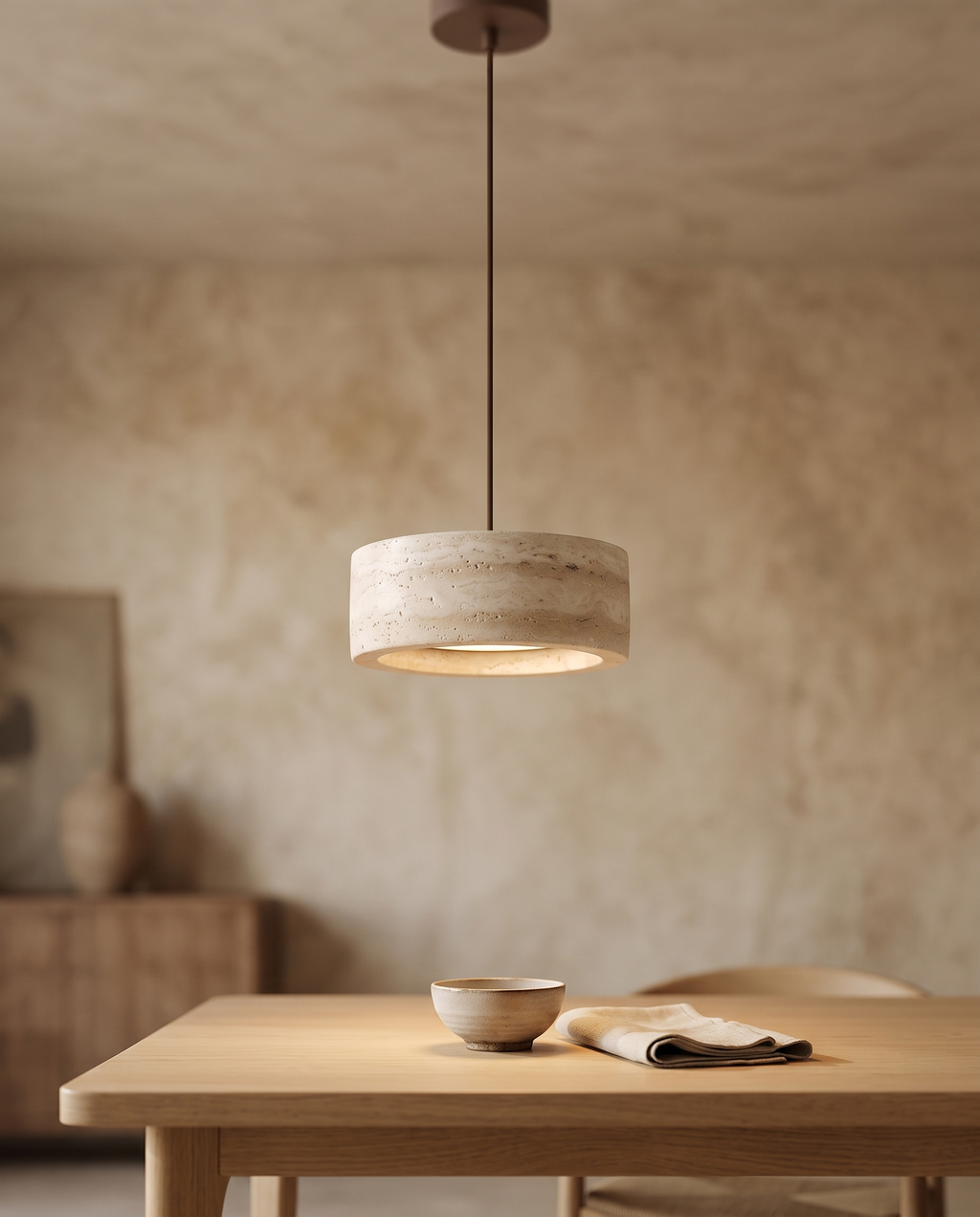 Travertine Stone LED Pendant Light, Dimmable — three-quarter angle over a Japandi dining table with aged plaster and light oak
