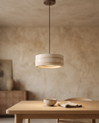 Travertine Stone LED Pendant Light, Dimmable — three-quarter angle over a Japandi dining table with aged plaster and light oak