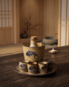 Ceramic Sake Pot and Cup Set, Hot or Cold — spirit pot and cups arranged on dark wood, zen Japanese interior, warm evening light hero
