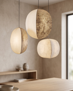 Linen Lantern Pendant Light, Fabric Shade — alternate three-quarter angle, Japandi dining space, gentle glow through linen