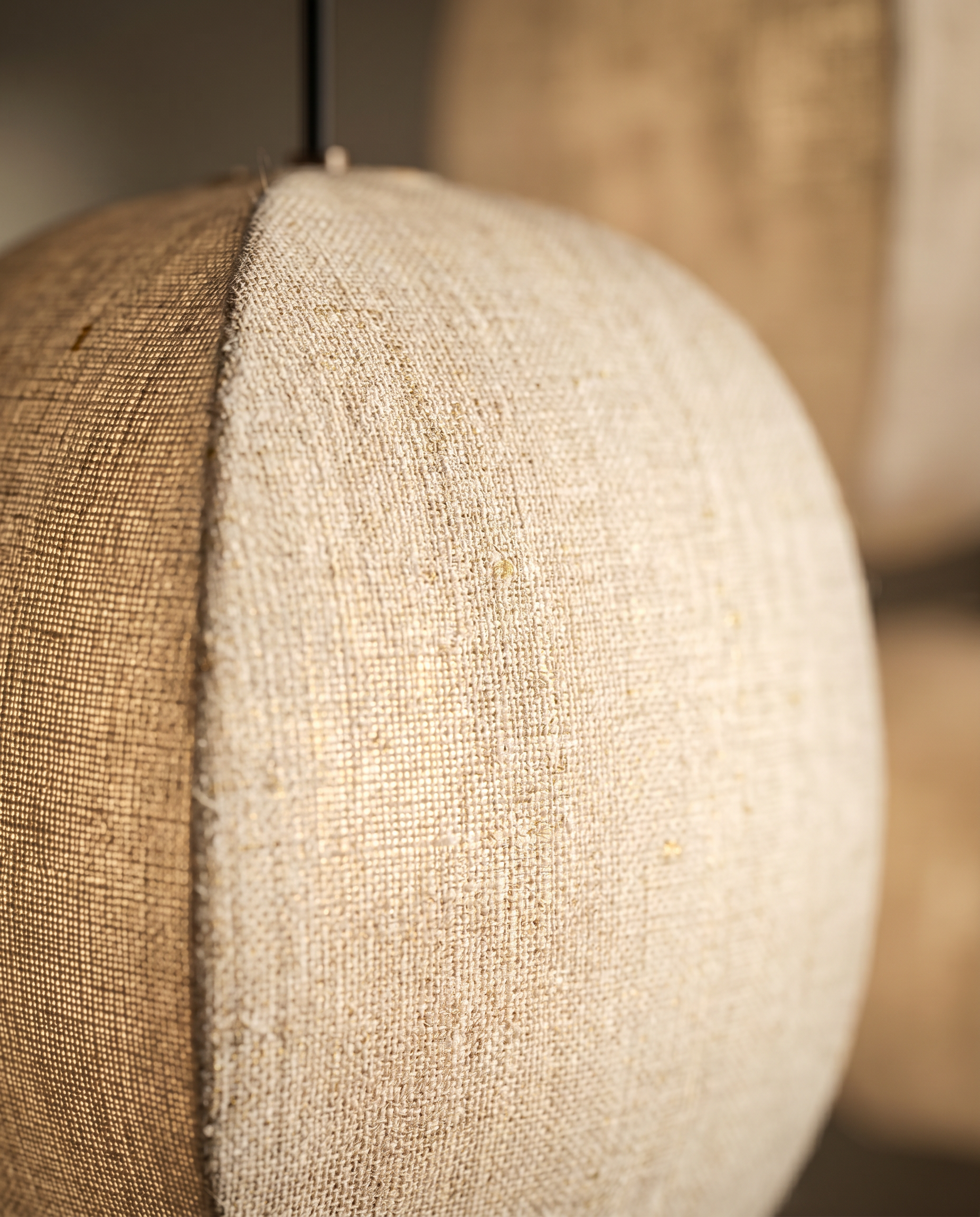 Linen Lantern Pendant Light, Fabric Shade — macro detail of woven linen shade texture, warm side light