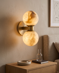 Marble Dual-Globe Wall Lamp, Gold Finish — hero above a nightstand in a Nordic bedroom
