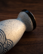 Handcrafted Ceramic Sake Set, Carafe and Cups — macro ceramic glaze detail, warm raking side light