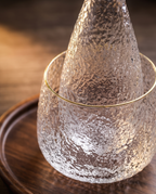 Glass Sake and Bar Serving Set, 6-Piece — macro detail, clear glass form and light refraction in warm side light
