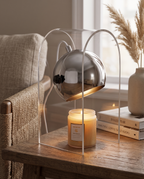 Frosted Glass Candle Warmer Lamp, Silver Finish — three-quarter alternate angle, modern living room side table, warm evening light