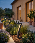 Solar Garden Path Lights, ABS Dusk-to-Dawn — alt angle along a planted border, villa terrace at dusk, soft warm light on foliage