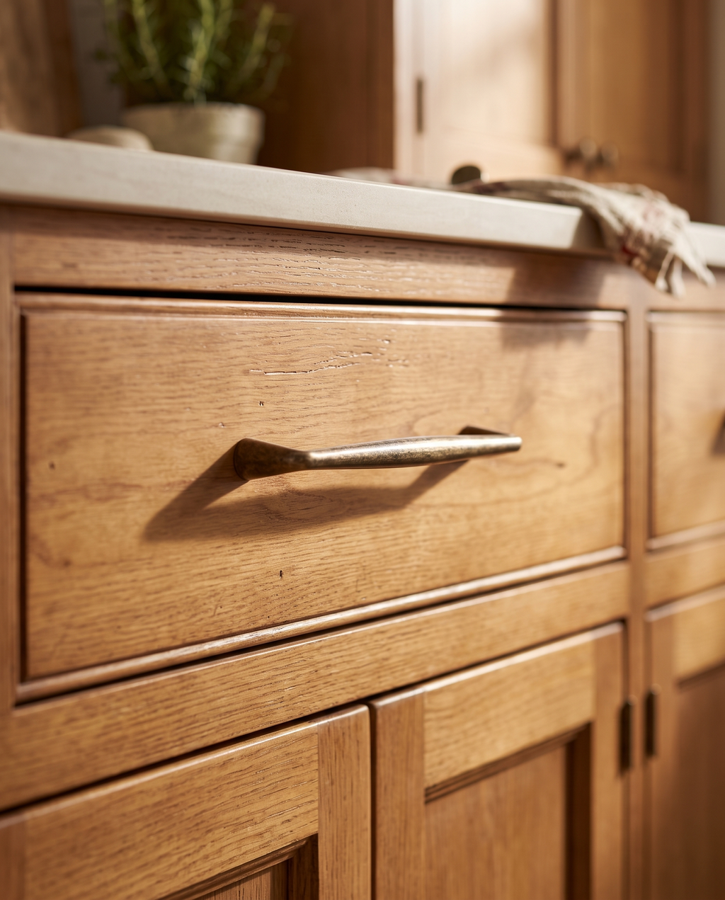 Antique Bronze Cabinet Handles and Knob, Zinc Alloy — mounted on a vintage kitchen cabinet drawer in warm honey wood