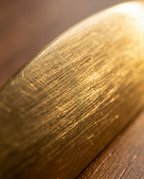 Brushed Brass Cabinet Pull, Antique Finish — macro detail, warm side light, brushed brass grain