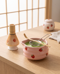 Strawberry Motif Matcha Tea Set, Ceramic and Bamboo — pink ceramic bowl and bamboo whisk, zen Japanese tea corner, hero arrangement on pale oak