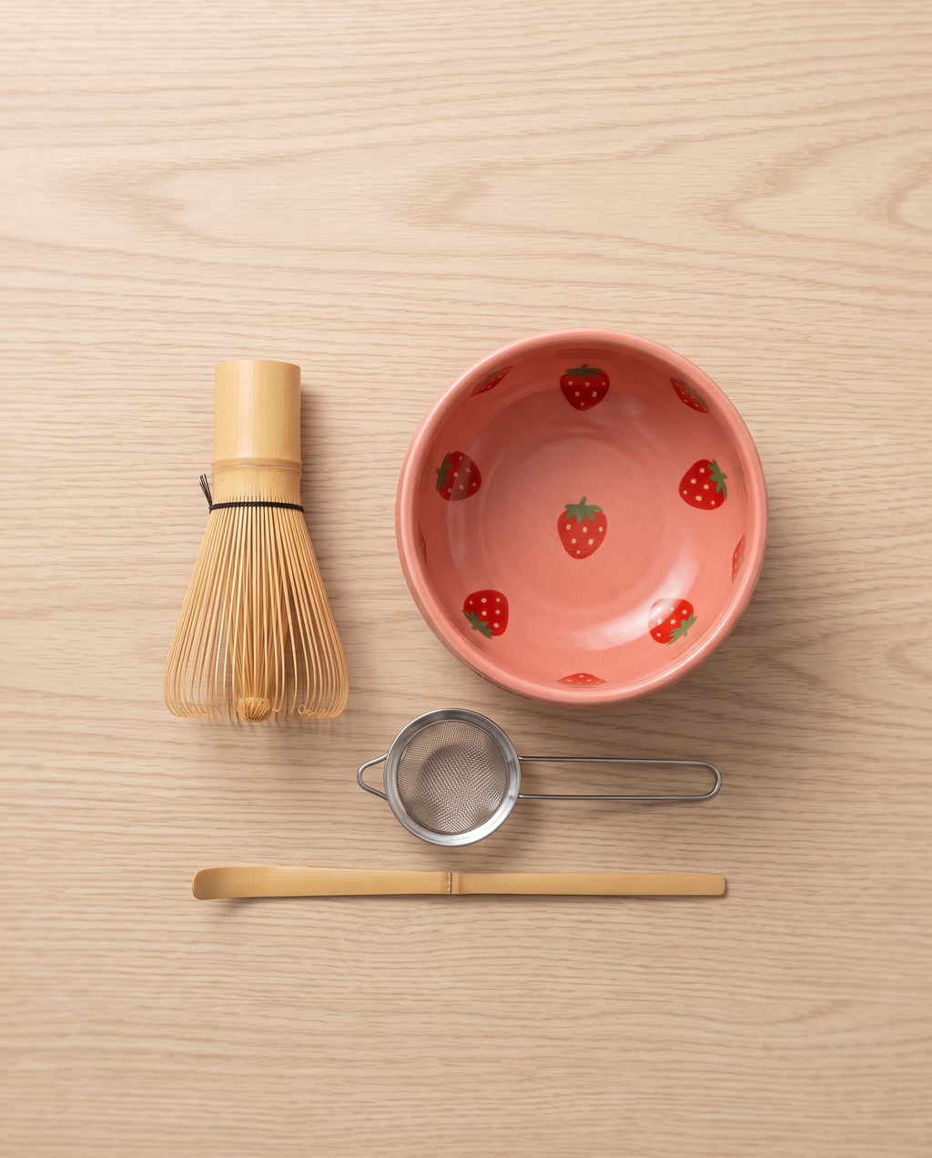 Strawberry Motif Matcha Tea Set, Ceramic and Bamboo — top-down flat-lay, minimal Japanese kitchen, overhead view of bowl and whisk
