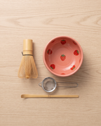 Strawberry Motif Matcha Tea Set, Ceramic and Bamboo — top-down flat-lay, minimal Japanese kitchen, overhead view of bowl and whisk