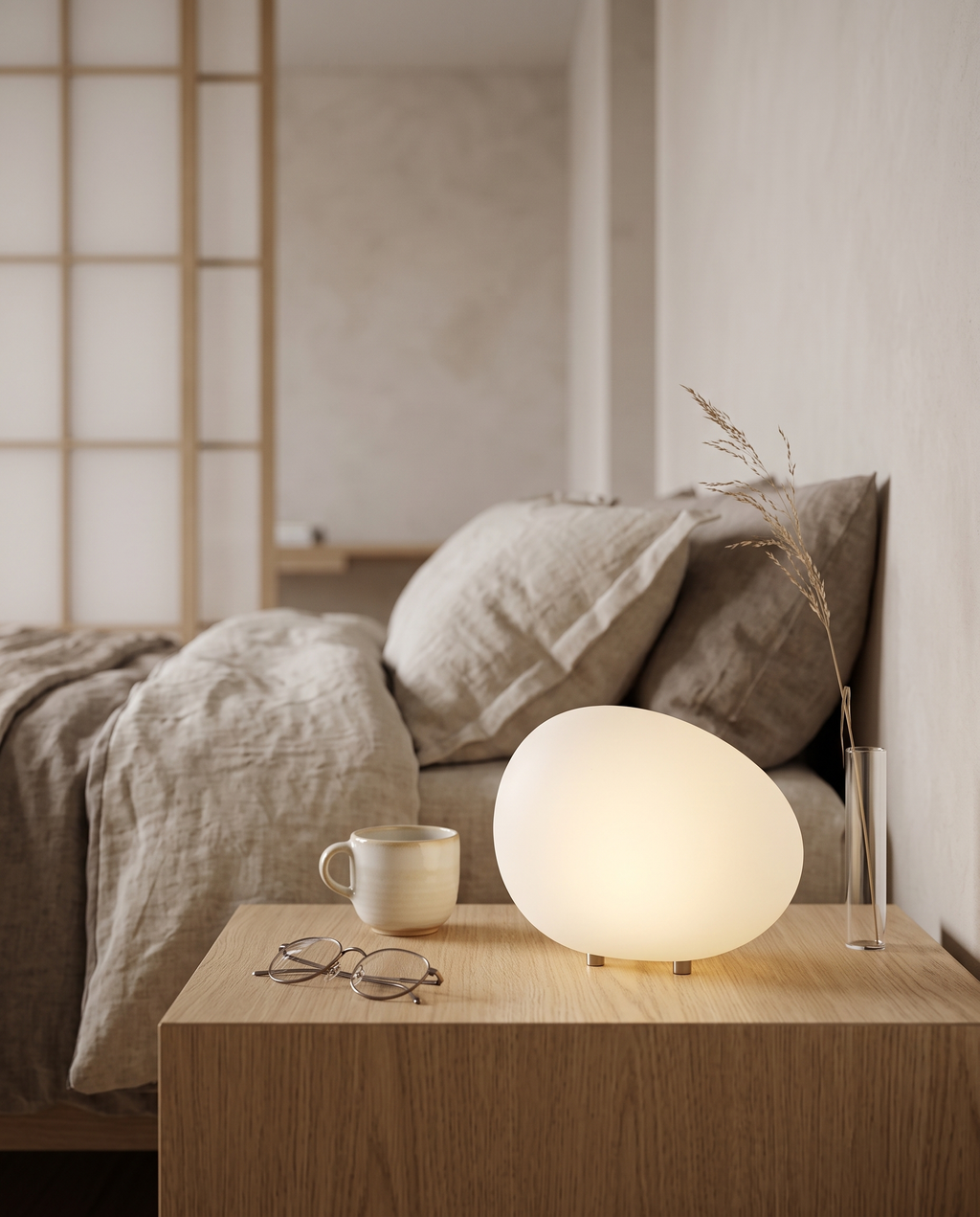 Pebble-Shaped LED Bedside Night Light — scale next to mug, glasses and vase on nightstand