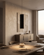Black Stone Cylinder Pendant Light, Natural Stone — hero hanging over a dining table, luxury modern apartment, warm glow below