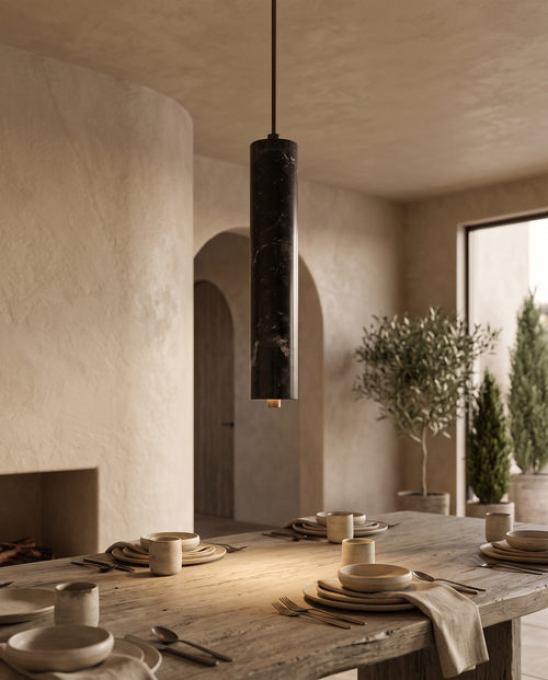 Black Stone Cylinder Pendant Light, Natural Stone — alternate angle over a Mediterranean-modern dining table, soft evening light