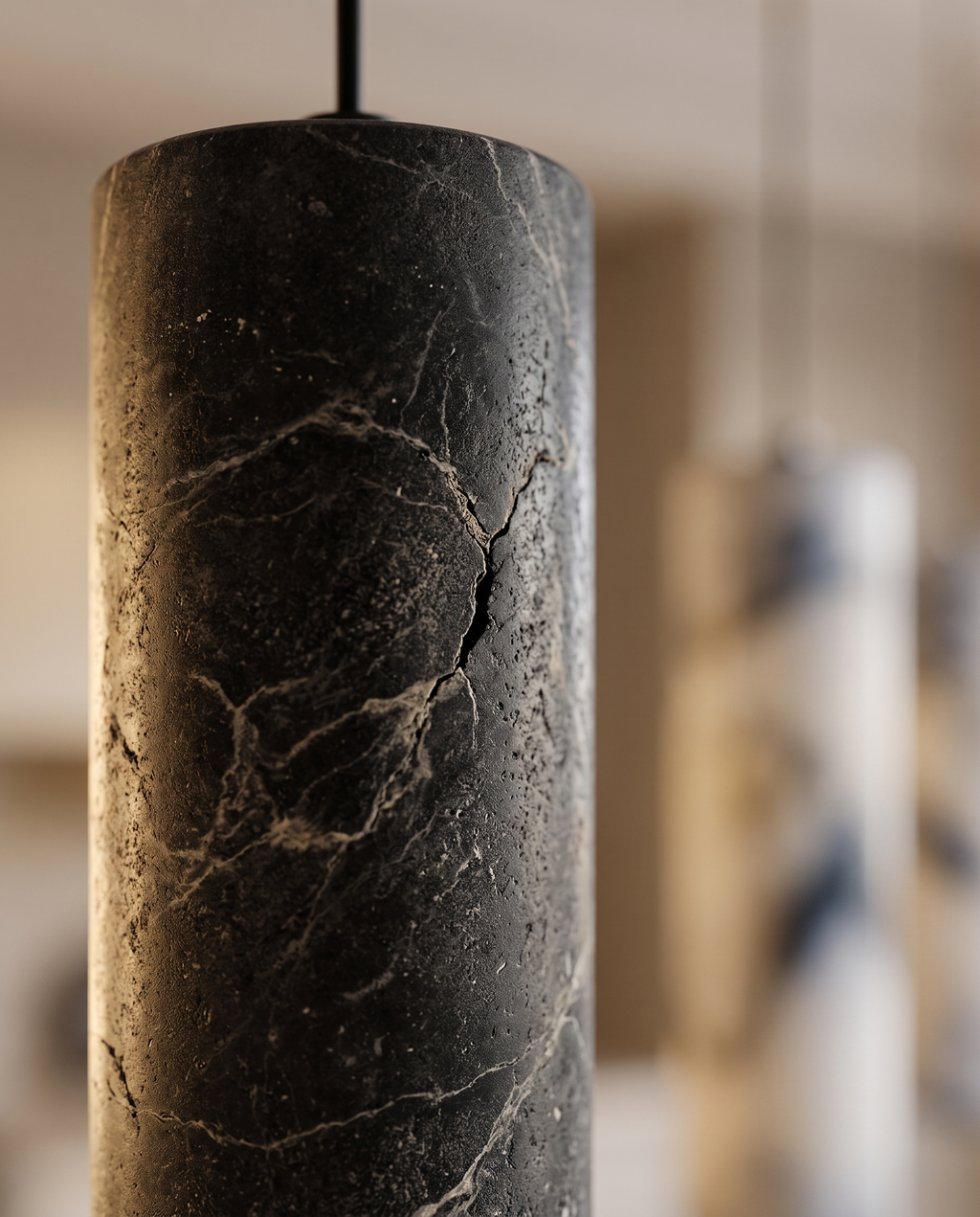 Black Stone Cylinder Pendant Light, Natural Stone — macro detail of black natural stone texture, warm side light