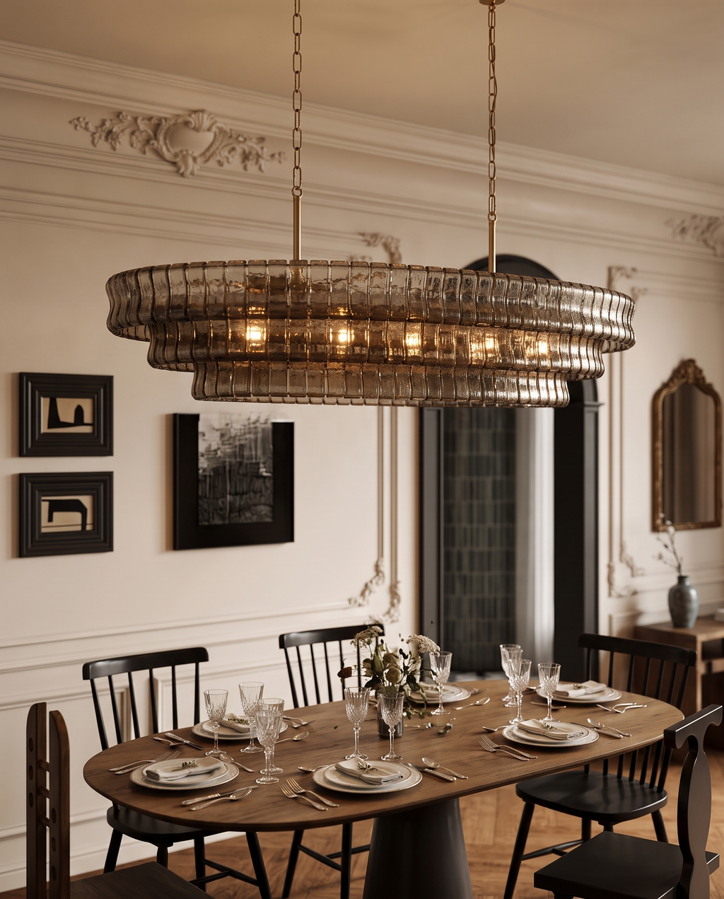 Gray Glass Oval Chandelier, Stainless Steel — hero over a dining table, elegant Parisian apartment, ornate moulding and warm evening glow