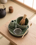 Green Pattern Matcha Tea Ceremony Set, Ceramic and Bamboo — top-down flat-lay, calm zen kitchen on pale oak, green-pattern ceramic bowl with bamboo whisk and scoop
