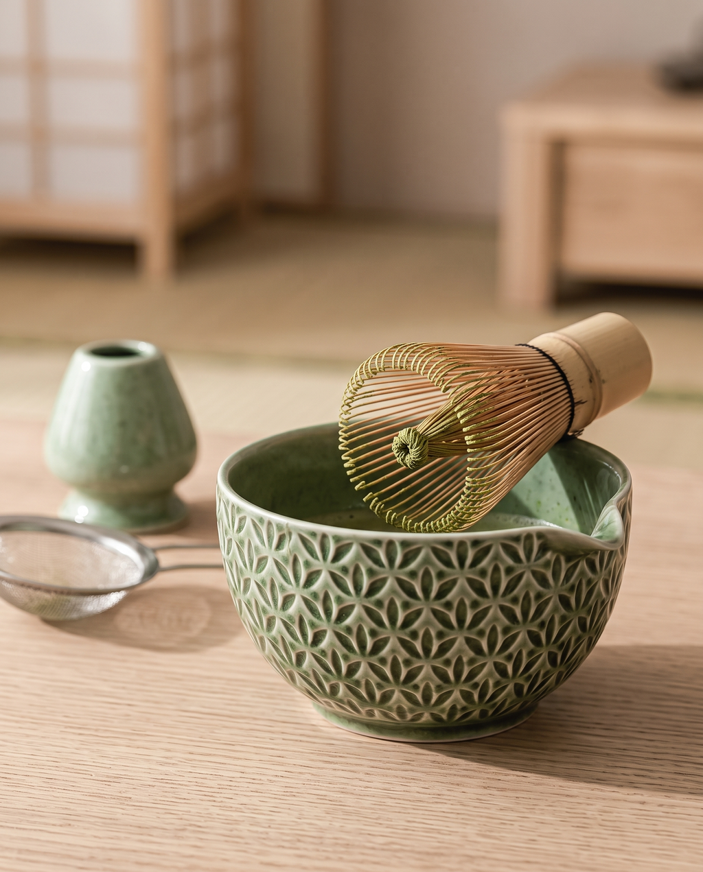 Green Pattern Matcha Tea Ceremony Set, Ceramic and Bamboo — macro detail, warm side light in a tea room, green-pattern ceramic bowl rim and bamboo whisk tines