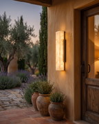 Outdoor LED Wall Light, Faux Marble and Steel — hero at a villa entrance at dusk
