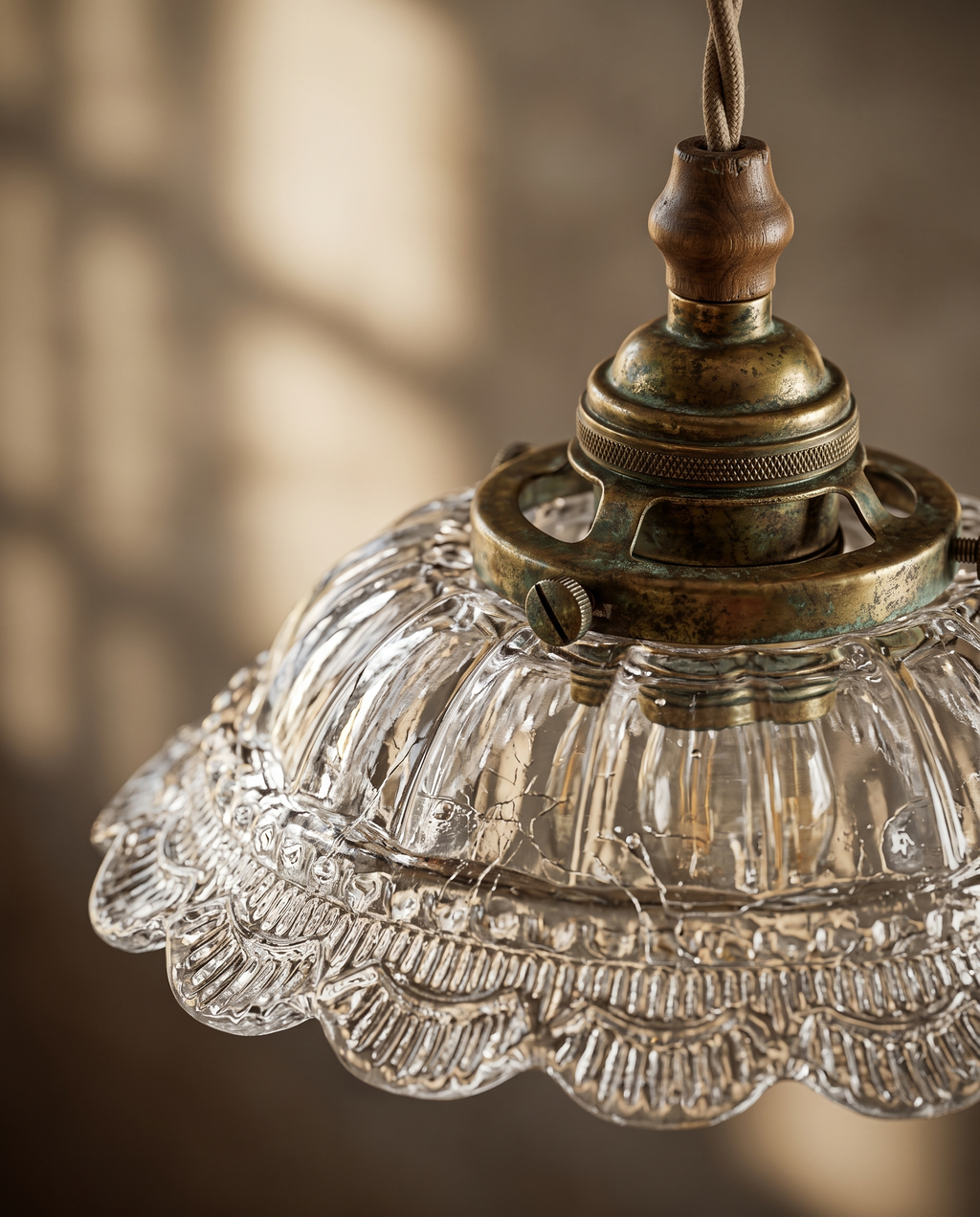 Walnut and Brass Pendant Light, Frosted Glass — detail macro, warm side light on textured glass shade and aged brass base