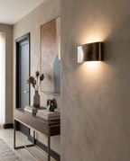 Curved Gold Up and Down Wall Light, Aluminum — placement view, modern wall with decor for scale