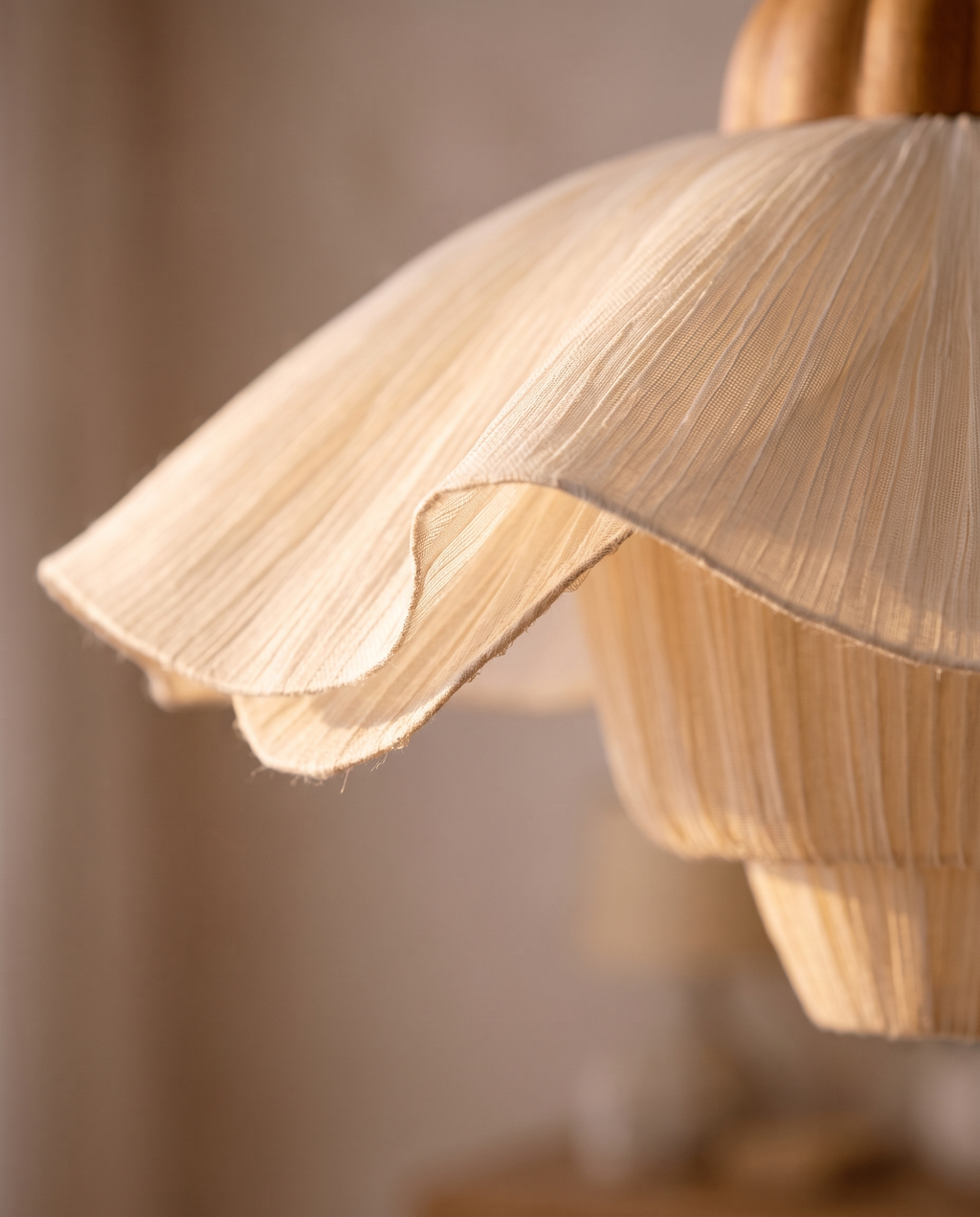 Pleated Petal Fabric Pendant Light, Cream — macro detail of the petal shade, warm side light grazing the translucent layers