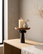 Turned Wood Pedestal Display Tray — hero on a Japandi oak console with a lit candle, warm natural light