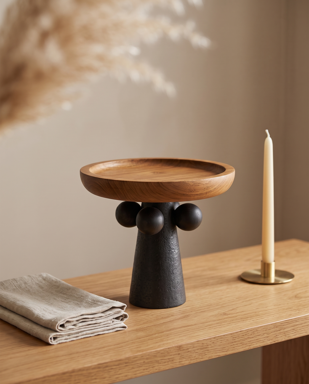 Turned Wood Pedestal Display Tray — three-quarter angle view, oak console, sculptural pedestal base detail