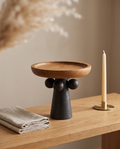 Turned Wood Pedestal Display Tray — three-quarter angle view, oak console, sculptural pedestal base detail