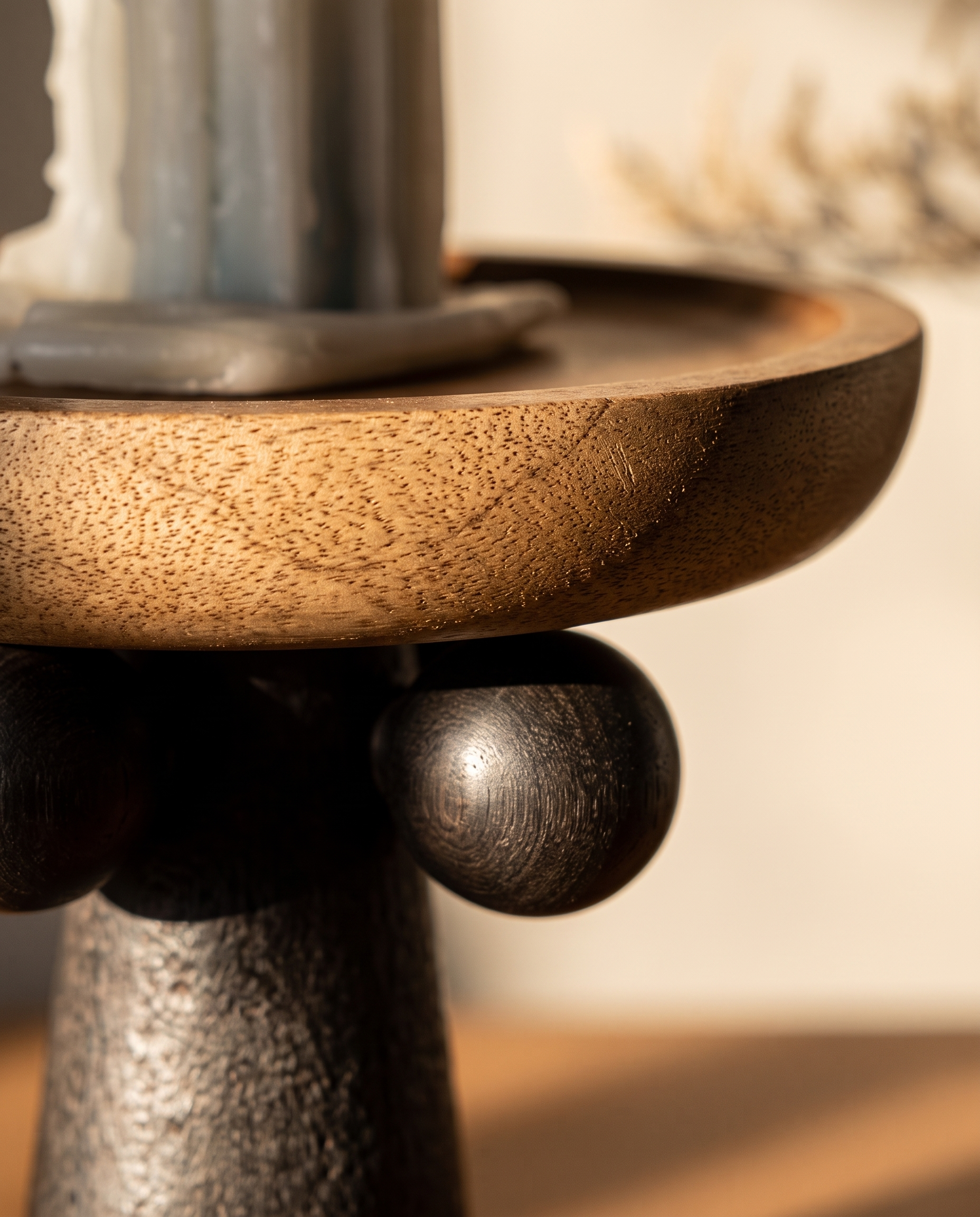 Turned Wood Pedestal Display Tray — macro detail, natural wood grain and turned curves in warm side light