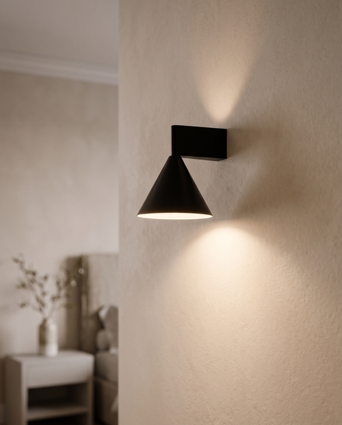 Black Cone Up and Down Wall Sconce, Aluminum — hero mounted, minimalist Italian bedroom wall, soft warm glow