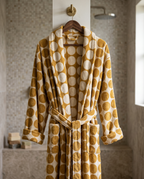 Dotted Jacquard Organic Cotton Bathrobe — on a wooden hanger, natural heavy folds, luxury spa bathroom