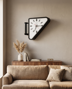 Dual-Sided Triangle Wall Clock — placement and scale shot above a sofa in a living room