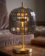 Stained Glass Table Lamp — macro detail of stained glass shade and gold iron base, warm side lighting