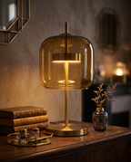 Stained Glass Table Lamp — Amber shade on styled aged-wood sideboard with books and vase for scale, warm Parisian Art Deco evening interior