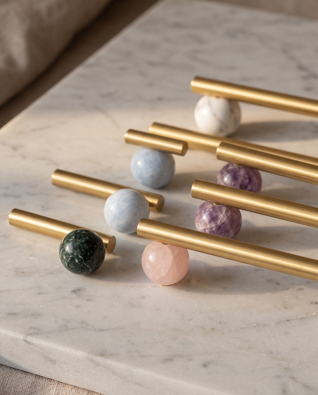 BlushStone Marble Brass Knob — group of colourways (green, pink, blue, purple, white) arranged together on a pale marble surface