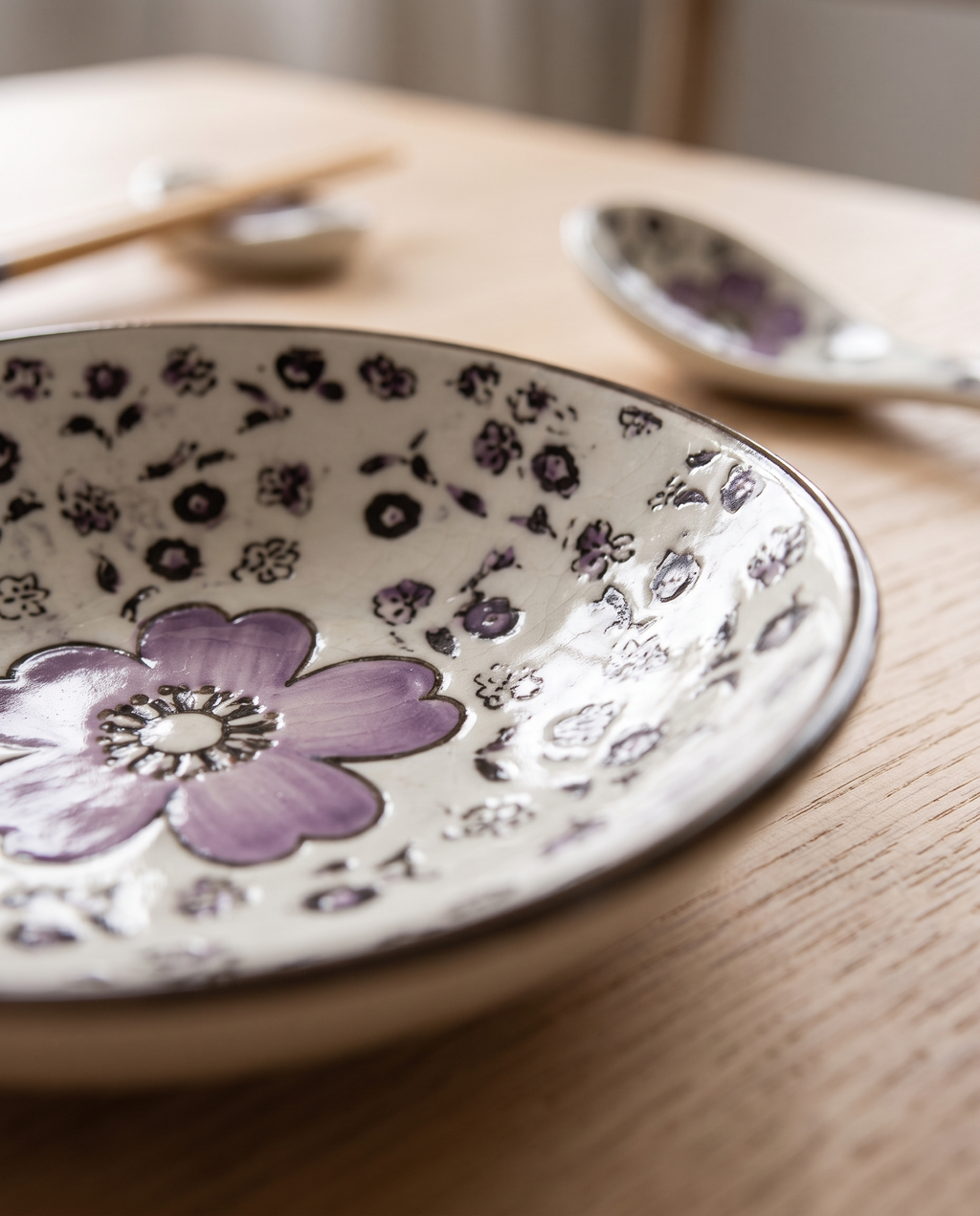 Cherry Blossom Sushi Dinnerware Set — cherry-blossom glaze macro detail, soft raking natural light on glossy ceramic