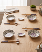 Cherry Blossom Sushi Dinnerware Set — full 12-piece set laid out for scale, pale oak table in a zen kitchen
