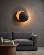 Round Moon Eclipse LED Wall Sconce, Copper — Black & Copper placement and scale, living room wall with furniture