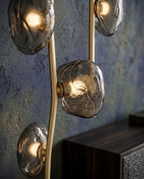 Sculptural Glass Floor Lamp, LED — macro detail of gold metal and smoky grey glass, warm LED glow