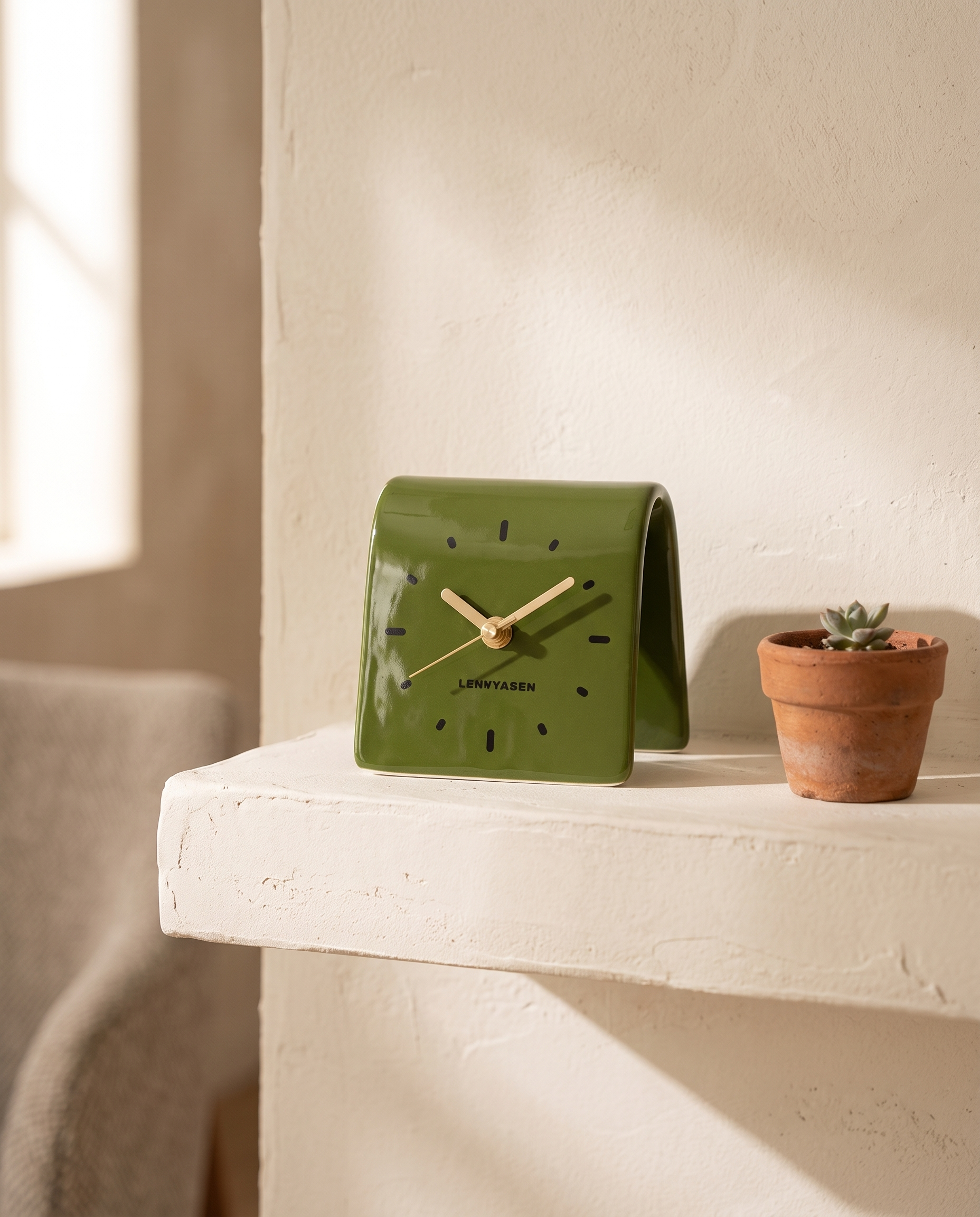 Square Ceramic Desk Clock, Silent — Olive, on a cream plaster shelf in a warm minimal living room