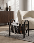 Leather and Metal Magazine Rack — Black, beside armchair in modern luxury living room